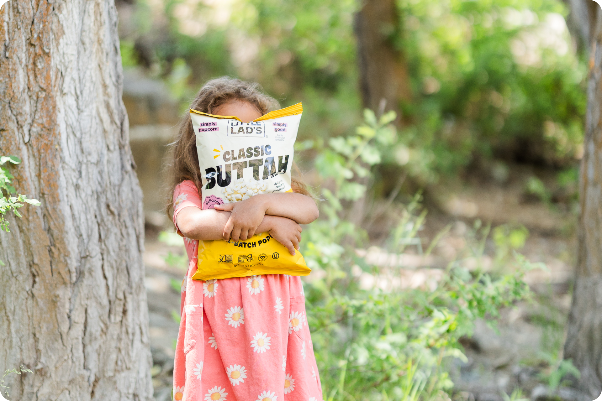 Little Lad's vegan certified small-batch popcorn bags including Savory Herbs, Sea Salt and Olive Oil, and Garlic Buttah on a clean background